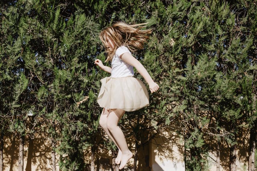 girl-dress-jumping-near-trees